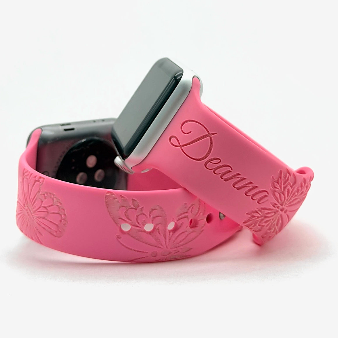 Pink watch band for Apple Watch with engraved butterflies around the band and a custom name