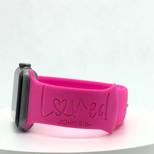 Side view of a hot pink watch band for Apple Watch engraved with Loved and John 3:16