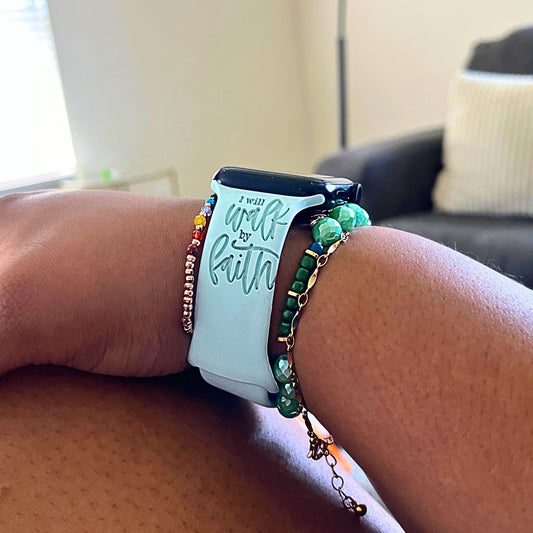 Light mint Walk by Faith watch band for Apple Watch worn, arm resting on a knee