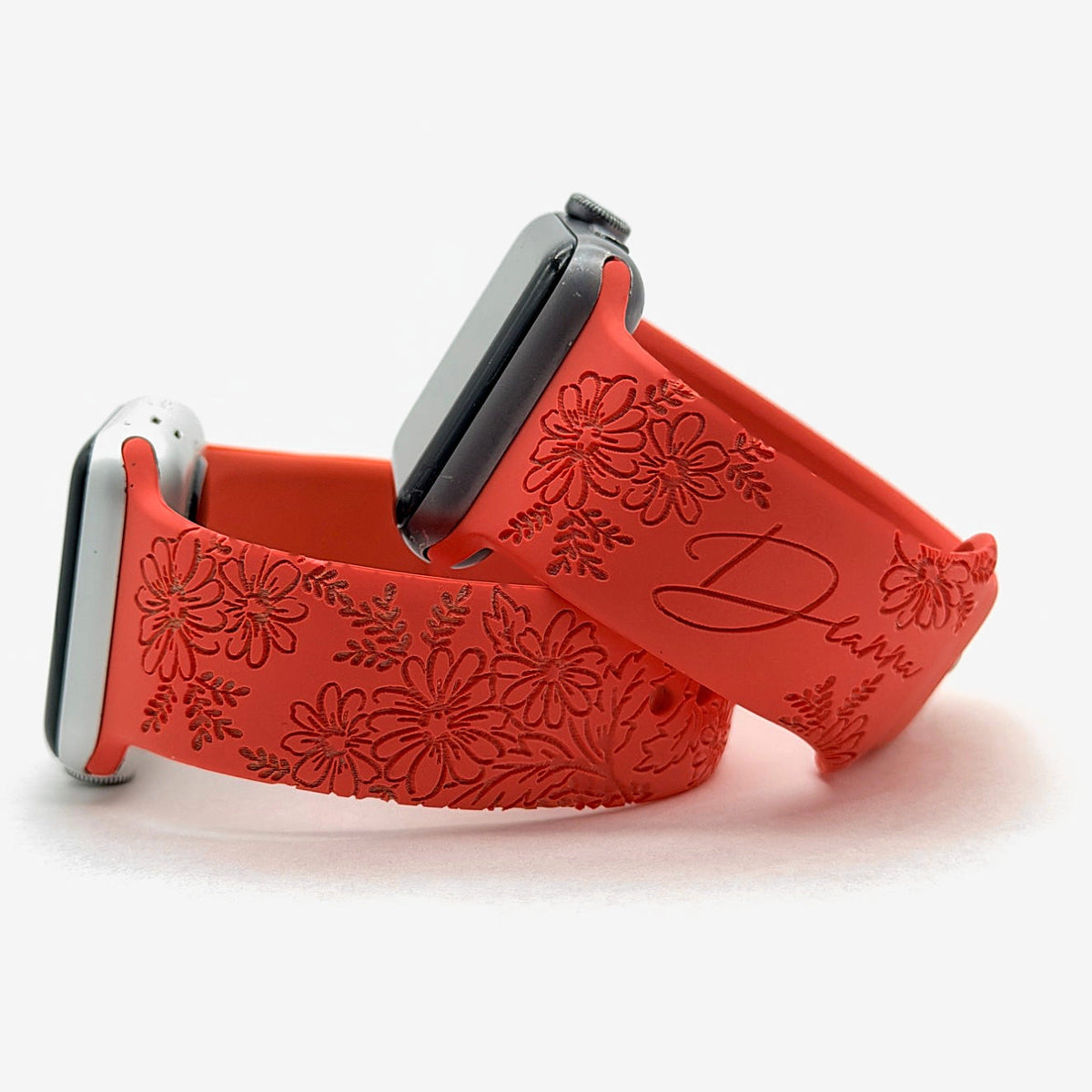 Red daisy floral watch band for Apple Watch engraved with a custom name and flowers, shown as a pair
