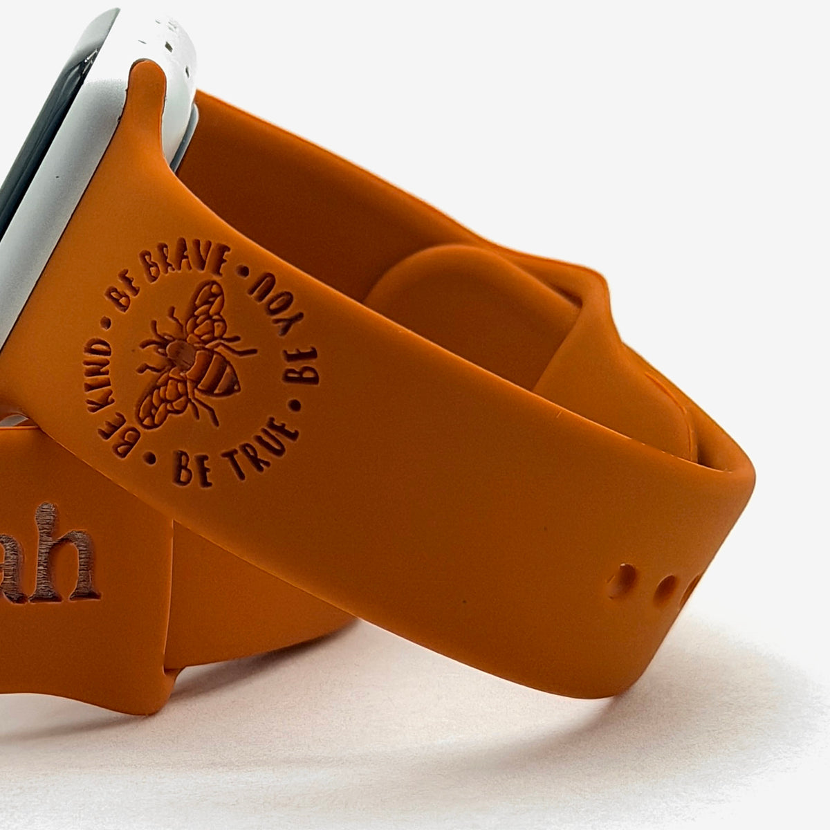 Be Kind Be Brave Bee design engraved on a rust silicone Brave watch band for Apple Watch