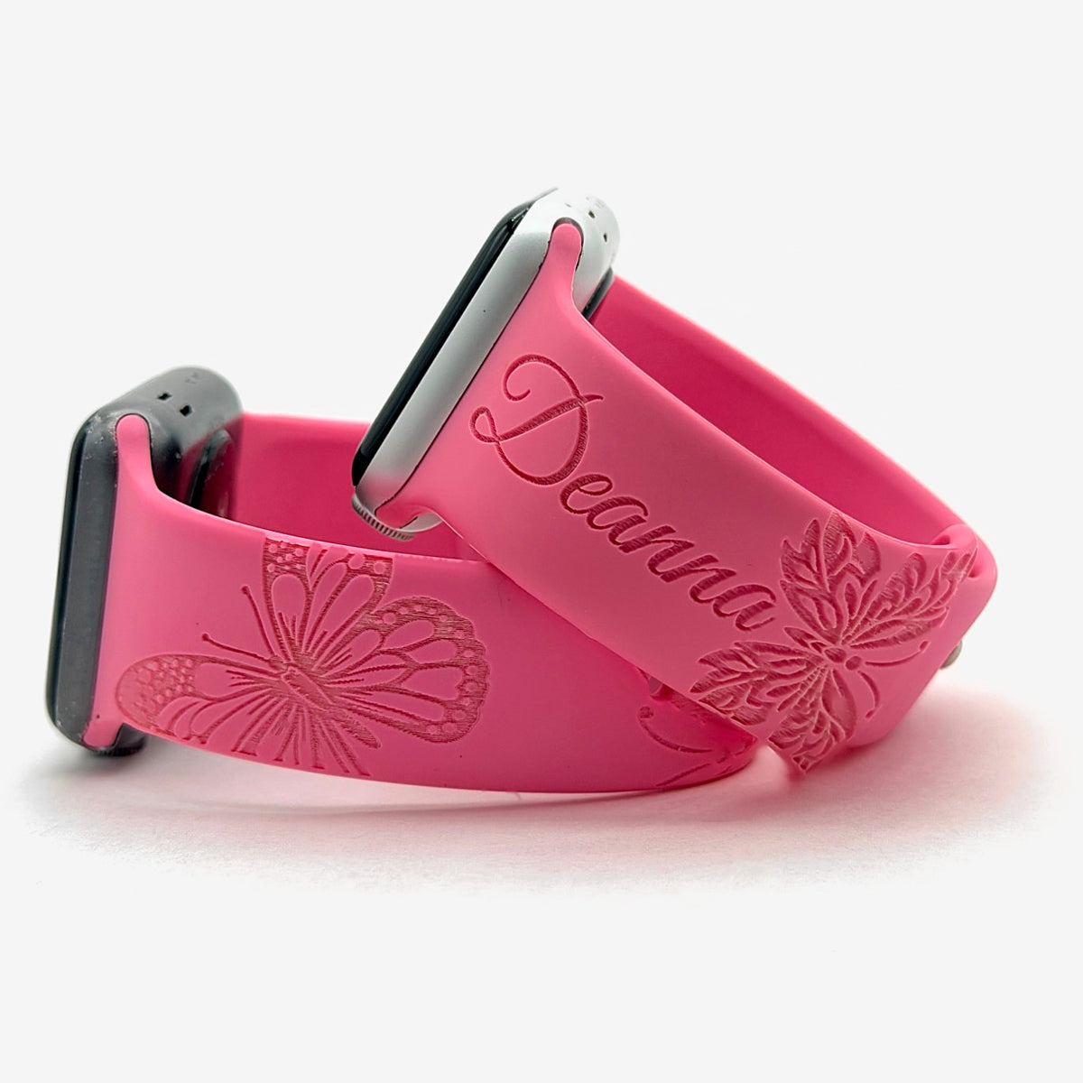 Pink butterfly watch band for Apple Watch engraved with a custom name and butterflies, shown as a pair
