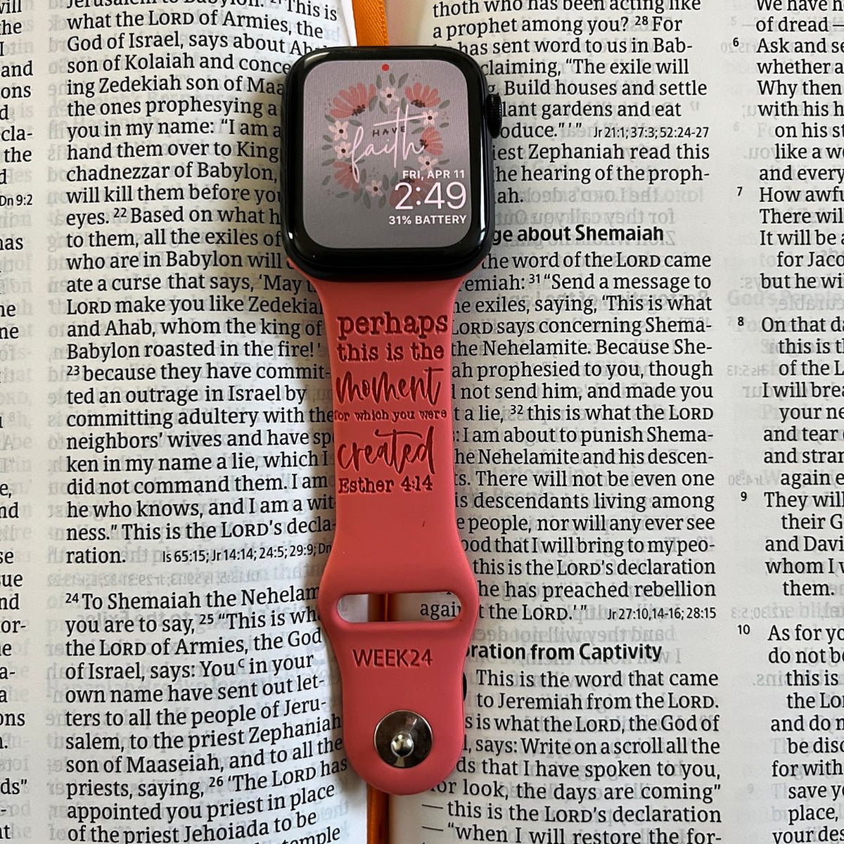 Coral Esther 4:14 watch band for Apple Watch laid on an open Bible, engraved with perhaps this is the moment for which you were created