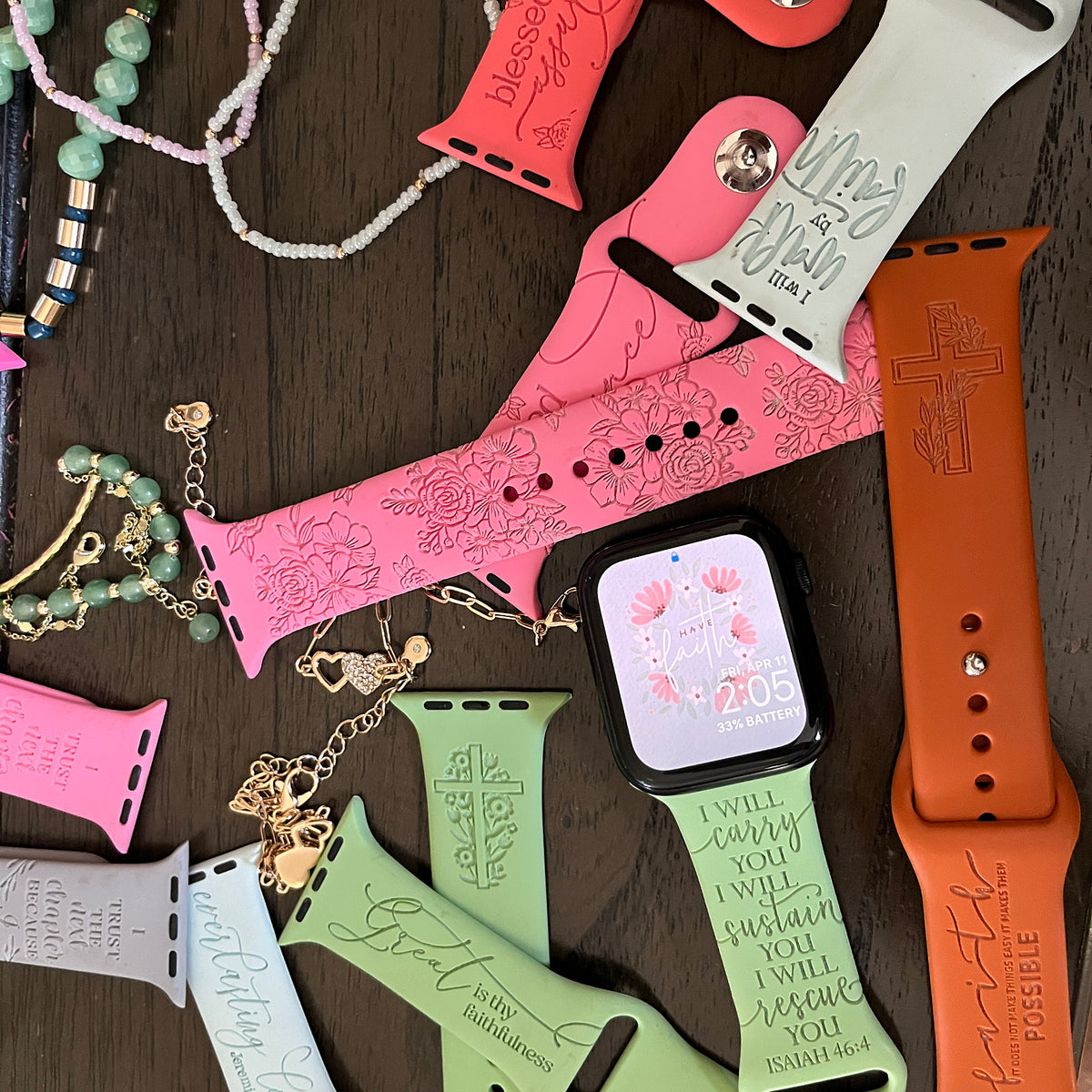Flat lay of colorful faith and scripture engraved watch bands for Apple Watch from the Rooted and Reminded collection