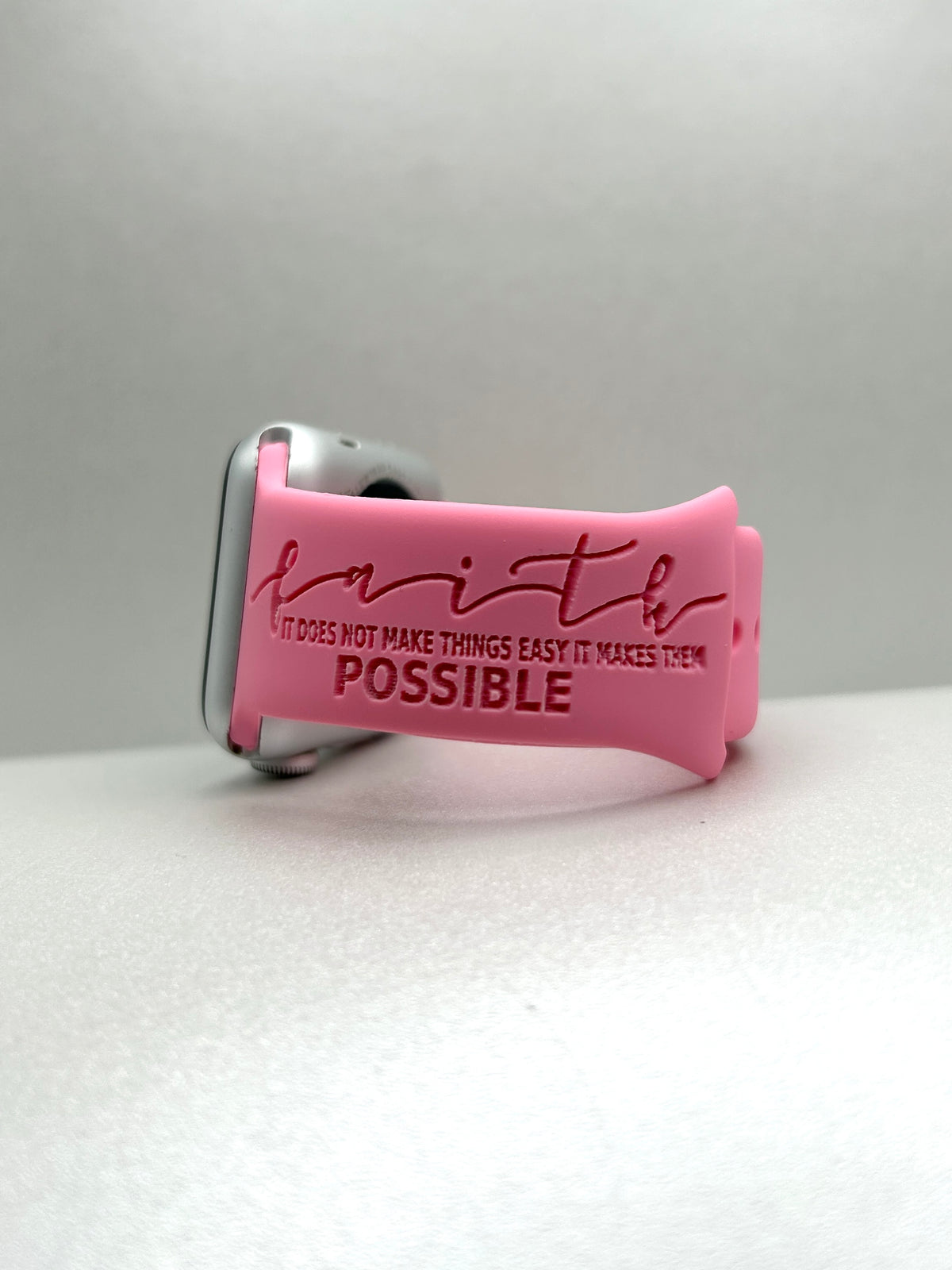 Pink Faith Makes It Possible watch band for Apple Watch showing the faith engraving