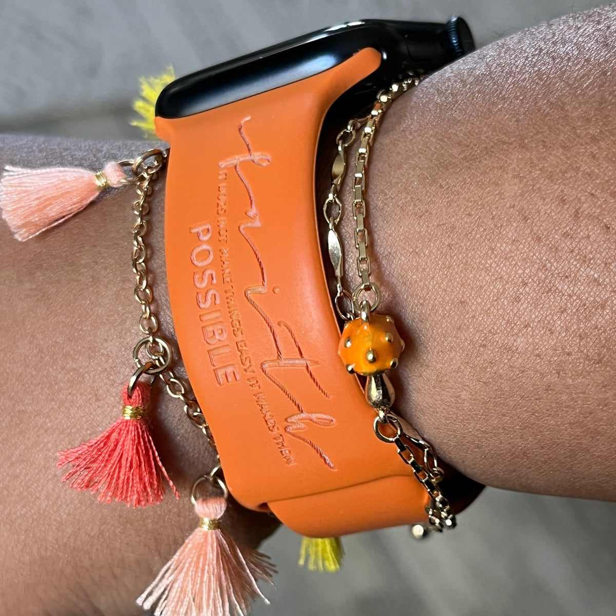 Rust Faith Makes It Possible watch band for Apple Watch worn with tassel and gold chain bracelets