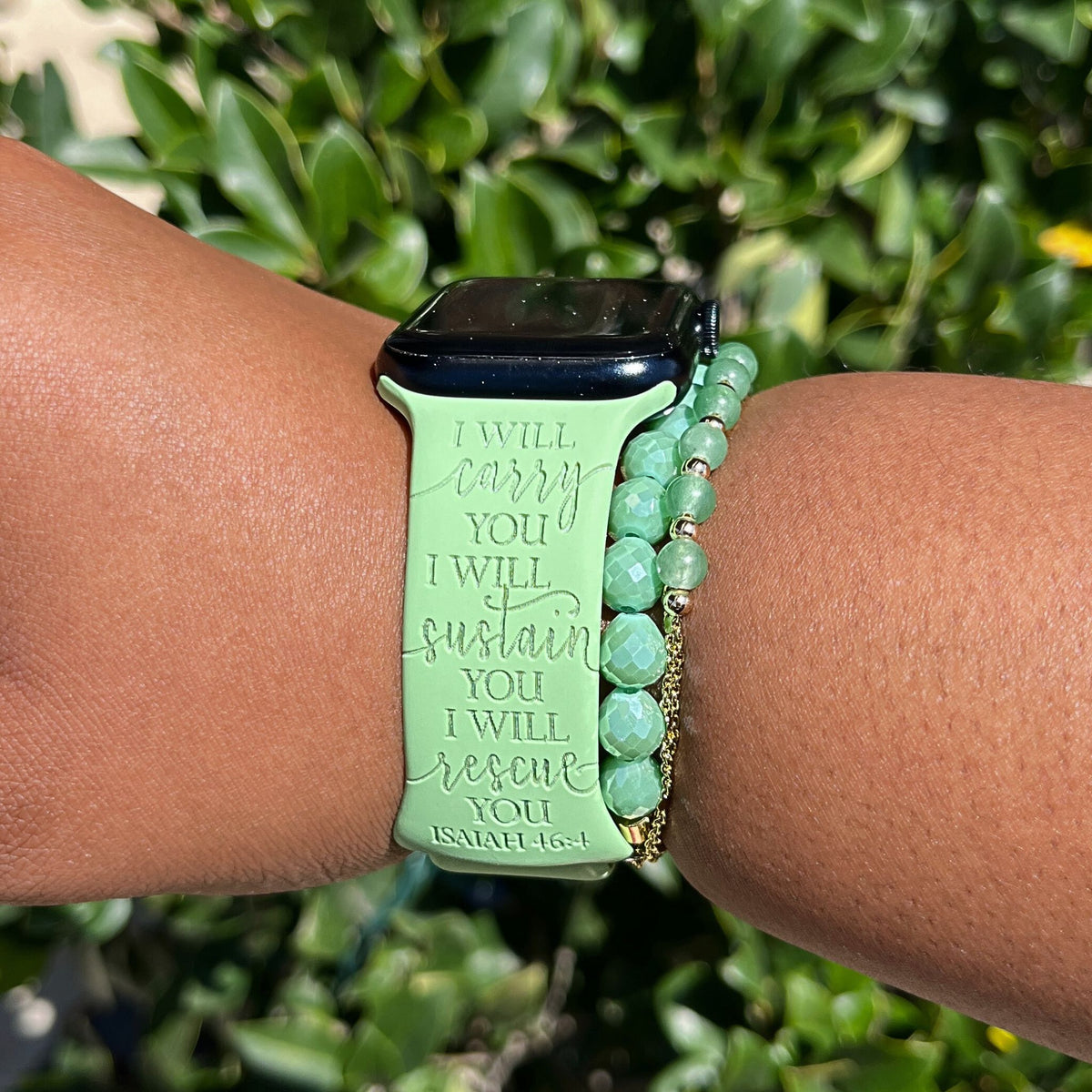 Green I Will Carry You watch band for Apple Watch worn outdoors beside greenery