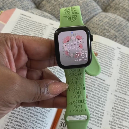 Green I Will Carry You watch band for Apple Watch held over an open Bible, second view