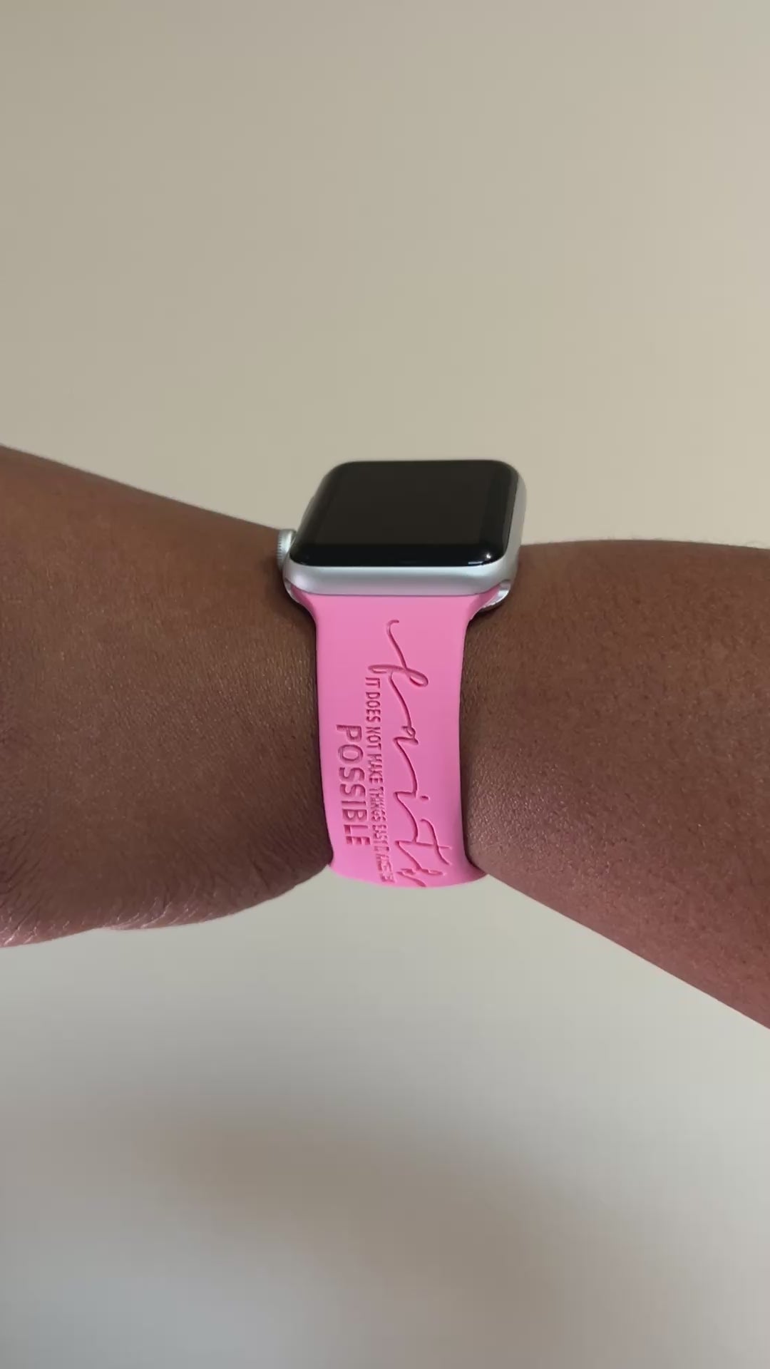 Pink Faith Makes It Possible watch band for Apple Watch worn on a wrist