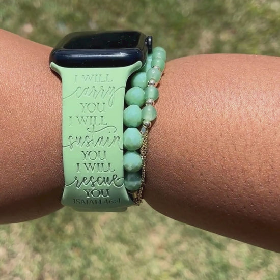 Close-up of the I Will Carry You engraving on a green watch band for Apple Watch, worn outdoors